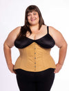 curvy plus size model wearing a beige cotton corset for fashion or waist training over black leggings and a black bra
