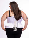 cute curvy corset model wearing a white satin corset over black leggings and black bra great for everyday wear fashion or waist training back lace up corset view