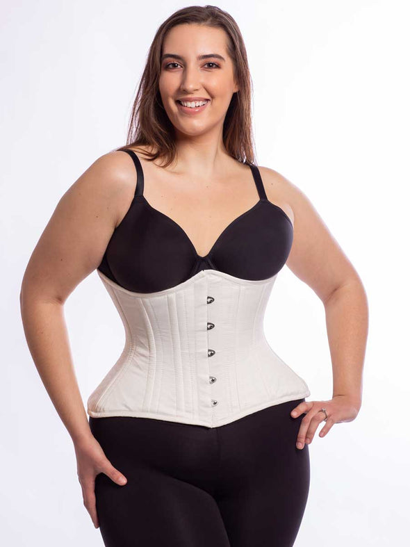 Cute model wearing the extreme curve cs 479 corset in ivory matte satin