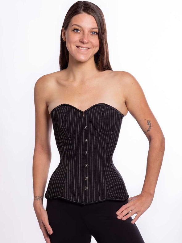 Cute model wearing a timeless black pinstripe corset top with black leggings