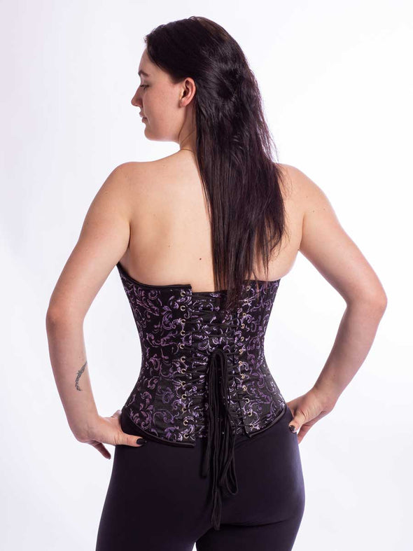 Smiling model wearing the cs530 purple and black brocade corset top back lace up view