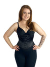 Smiling model wearing the cs220 waist training corset over leggings and a bra front view