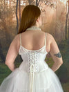 Back Lace up corset view of a Model standing in fantasy forest wearing a white fairycore dress with a white waspie corset and pearls cs-220 waist training corset for weddings and boudoir shoots