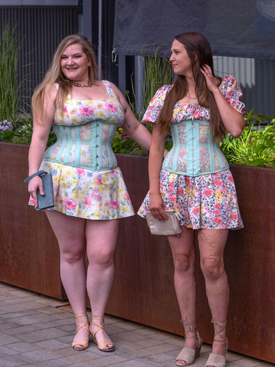 Two models one slender and one curvy in summer floral dresses nd Romantic Curve cs-411 longline mesh corsets chatting