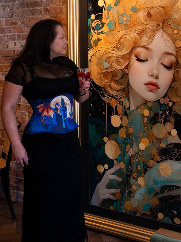 Woman wearing a corset with a castle design in front of an artistic depiction of a woman with blonde hair.