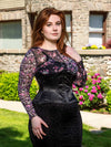 Model wearing the hourglass curve 426 standard waist training corset in black with a floral sheer top and black skirt