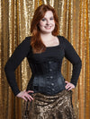 cute model wearing a black satin waist corset with hip ties over a sequin skirt and sweater