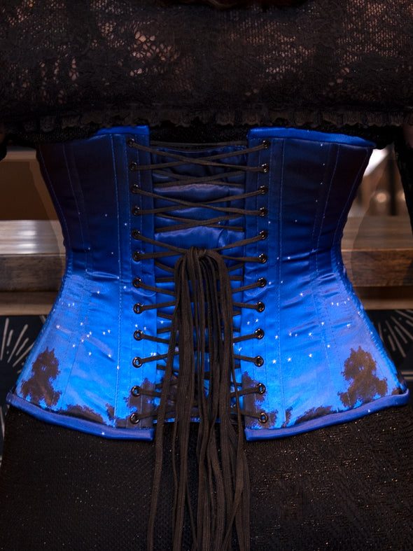 CS426 hourglass curve Blue corset with lace-up back on a dark background