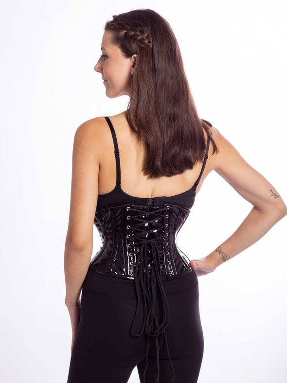 cute model wearing the cs201 waspie corset in black pvc back lace up view