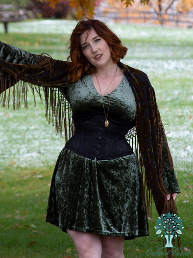 Model wearing the cs-219 romantic curve black mesh waspie waist training corset over a green mini dress with burnout velvet scarf and gold locket
