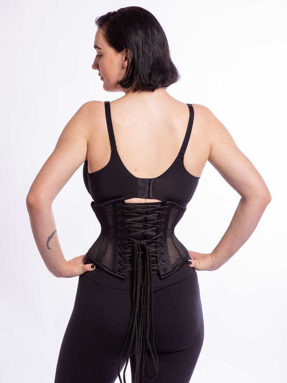 product shot of model wearing the romantic curve cs219 corset in black sport mesh back lace up view