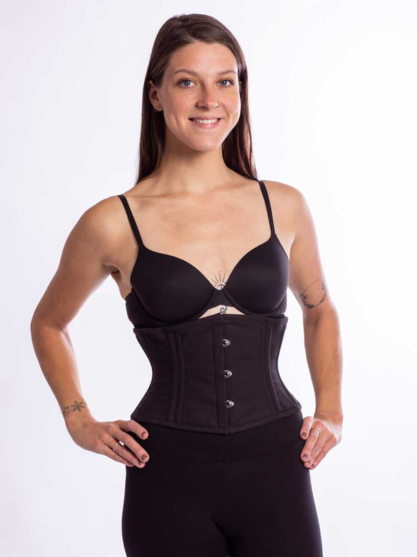 cute smiling model wearing the cs301 waspie corset in black cotton front view