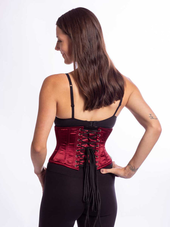 model wearing the new design cs 301 waspie corset in red wine satin back lace up view