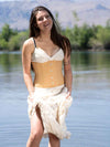 Female Model wearing the cs305 beige cotton corset with a cotton and lace sundress