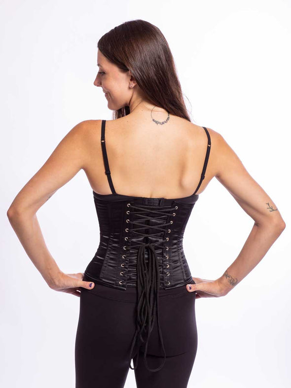 cute model wearing the gentle curve of the cs 305 black satin corset back lace up view