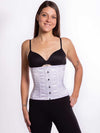Cute athletic build model wearing a modern curve corset in white satin with black leggings and black bra