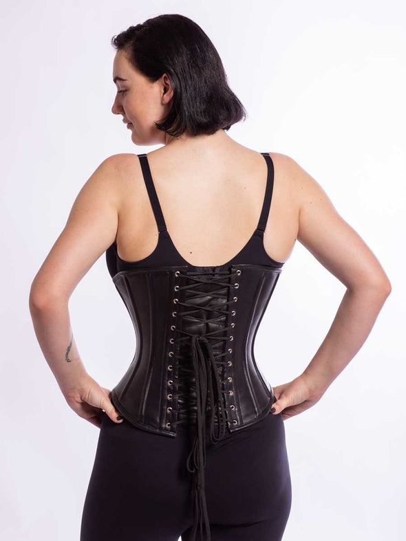 Model wearng the cs 345 romantic curve corset in black leather back lace up view