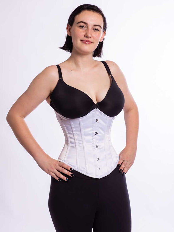 Model with feminine curves wearing the cs 345 corset in silky white satin