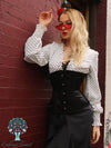 Blonde model wearing the romantic curve cs411 longline in black satin posing against a brick red wall with red sunglasses and lipstick