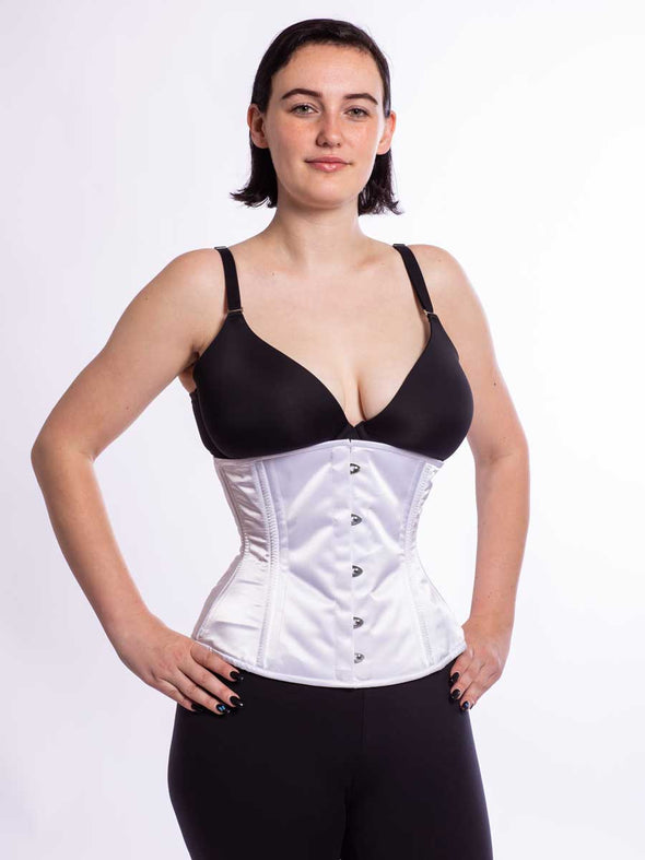 cute model wearing the cs 411 longline romantic curve corset in soft silky white satin