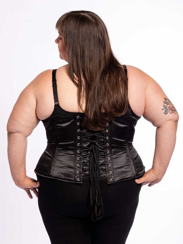 cute corset model wearing black bra and leggings with a black satin cs 411 longline full figure plus size corset back lace up corset view