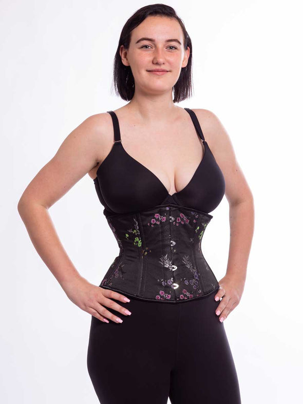 Beautiful midnight brocade corset over leggings and a bra on a cute female model
