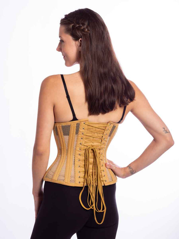 smiling model wearing the cs426 standard corset in beige mesh back lace up view