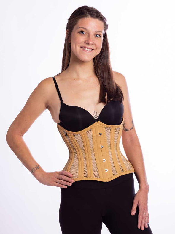 smiling model wearing the cs426 standard corset in beige mesh