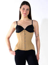 smiling model wearing black leggings and bra with an houglass beige corset to complete the outfit