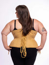 Back lace up corset view of a curvy plus size model wearing a beige corset for waist training and fashion over black leggings and bra