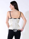 curvy model wearing black tight and bra with an ivory corset with hip ties