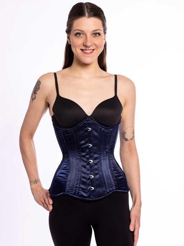 cute corset model wearing a black bra and black tights with a navy longline everyday corset  for waist training