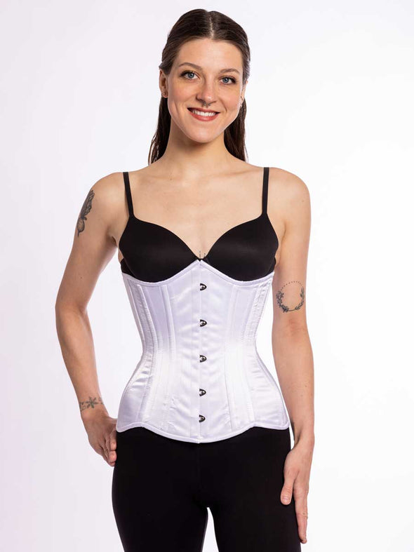 cute corset model wearing a black bra and leggings with a white longline everyday corset for waist training