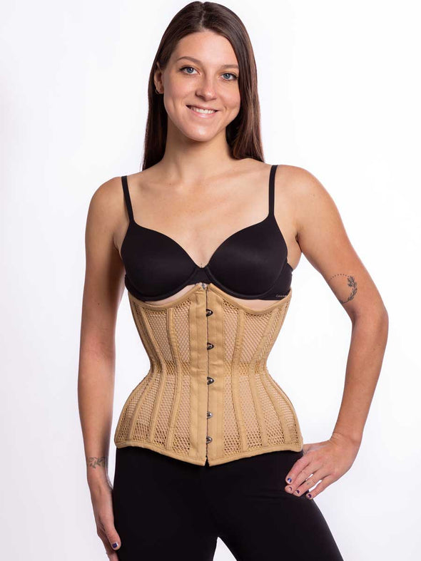 Smiling model wearing black leggings and bra sporting a beige hourglass curve mesh corset