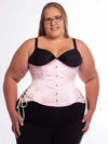 Curvy plus size model wearing the cs426 hourglass curve corset in light pink with hip ties 
