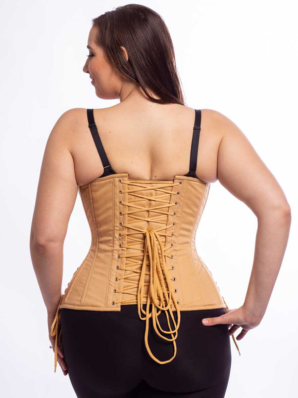 Model wearing cs426 longline beige cotton steel boned corset corset with hip ties back lace up view
