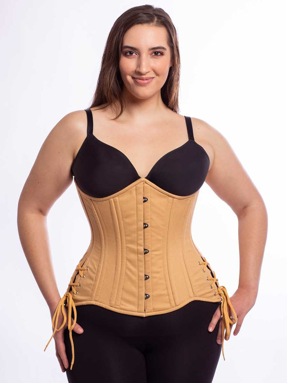 Model wearing cs426 longline beige cotton steel boned corset corset with hip ties front view