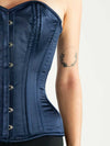 Rich navy satin corset top with boning worn with black leggings close up view of the premium fabrics and detailing