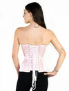 Back lace up corset view of a Smiling model wearing a pale pink strapless corset top over black leggings
