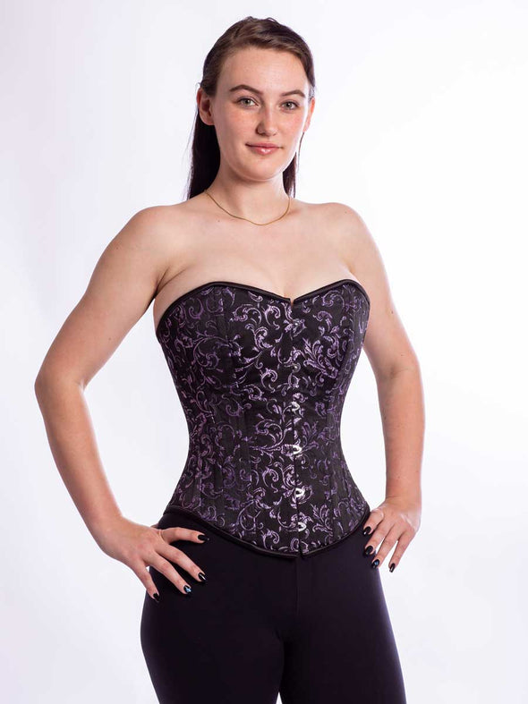 Smiling model wearing the cs530 purple and black brocade corset top back 