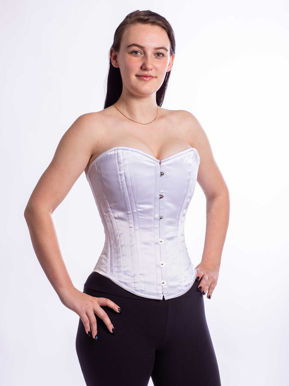 Cute model wearing the cs530 corset top in silky white  satin