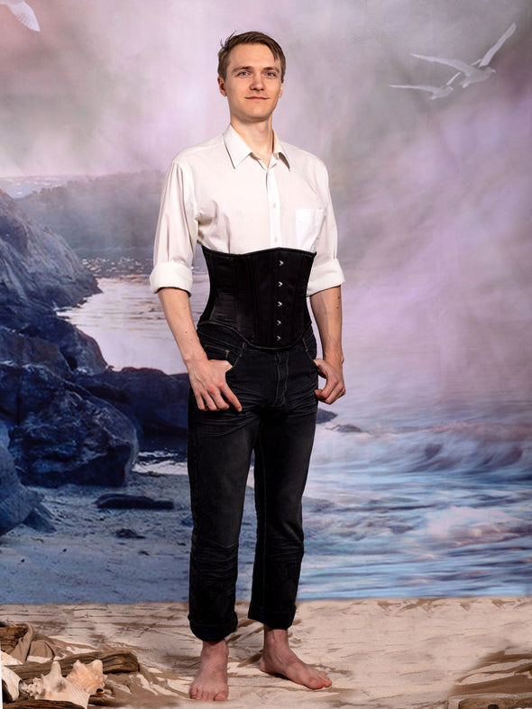 Male corset model wearing the black satin modern curve cs-701 waist training corset with dark jeans and a white shirt