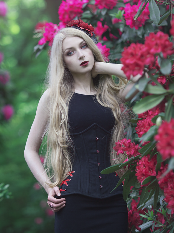 model wearing the cs426 longline black cotton steel boned corset with hip ties front view