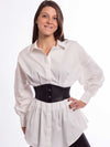 Cute model in a white cotton blouse wearing a black leather corset belt