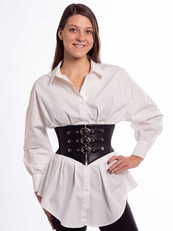 Woman in a white tunic with a black steampunk best with buckles and snaps