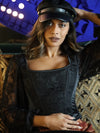 cute model wearing black satin and lace cropped corset top with sleeves worn with a black hat for holidays