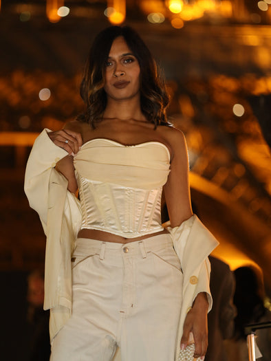 Ivory satin fashion corset top with chiffon cowl neck worn with an ivory coat and pants and a pearl bag