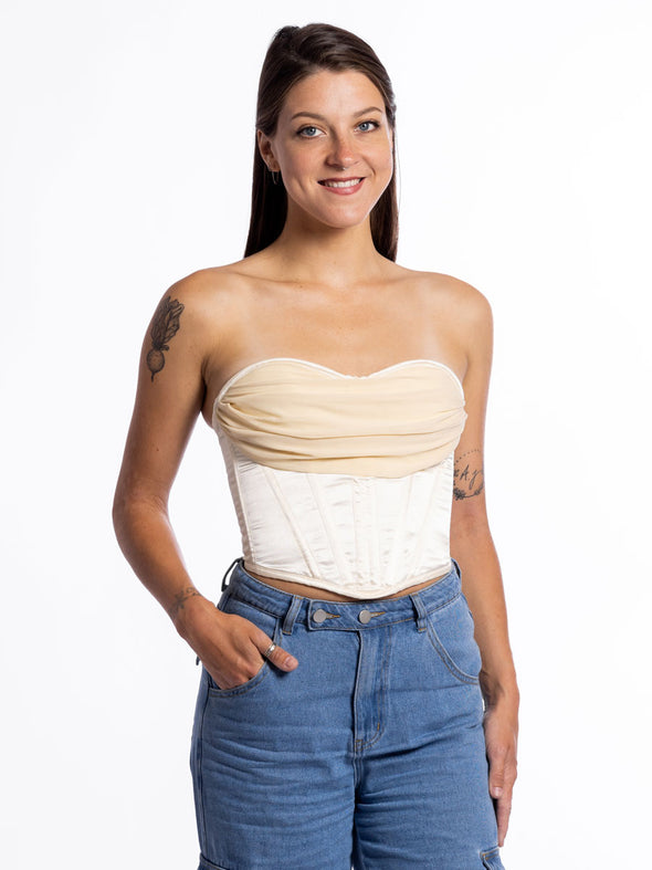 Ivory fashion corset top worn with jeans and boots