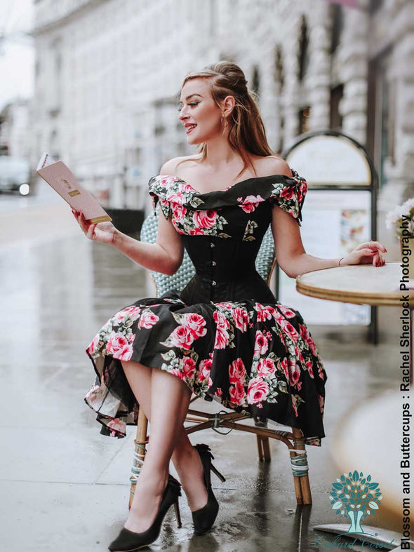 blossom and buttercups sitting at a cafe in a black floral dress under the cs 411 longline romantic curve corset