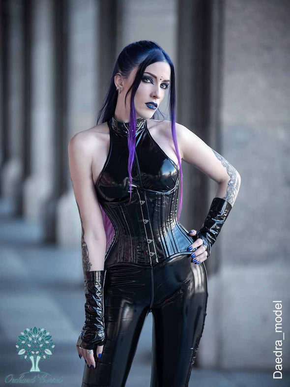 daedra_model wearing the black pvc cs426 hourglass curve corset with a black latex bodysuit and fingerless gloves